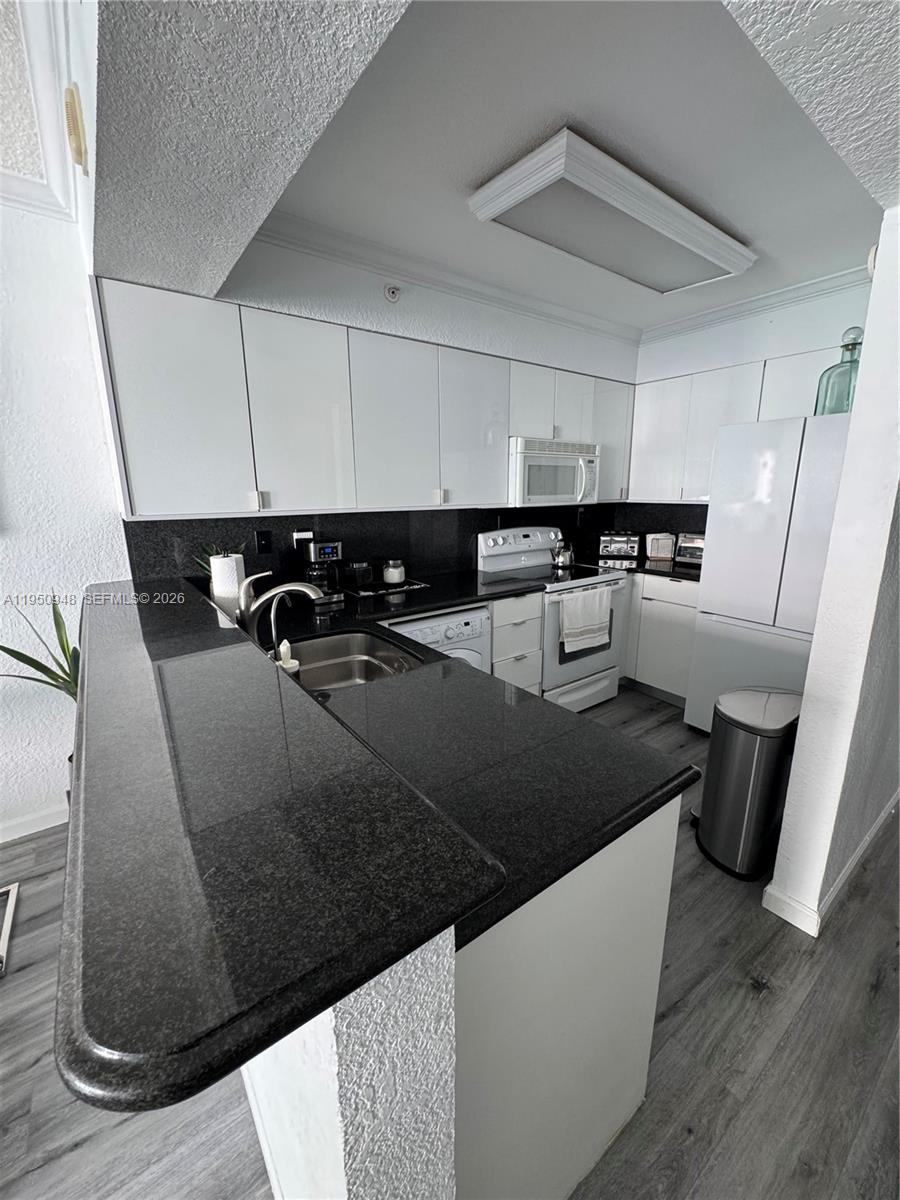 2501 South Ocean Drive, Unit 1105 Hollywood, FL 33019 - Photo 6 of 45 a kitchen with a sink and cabinets