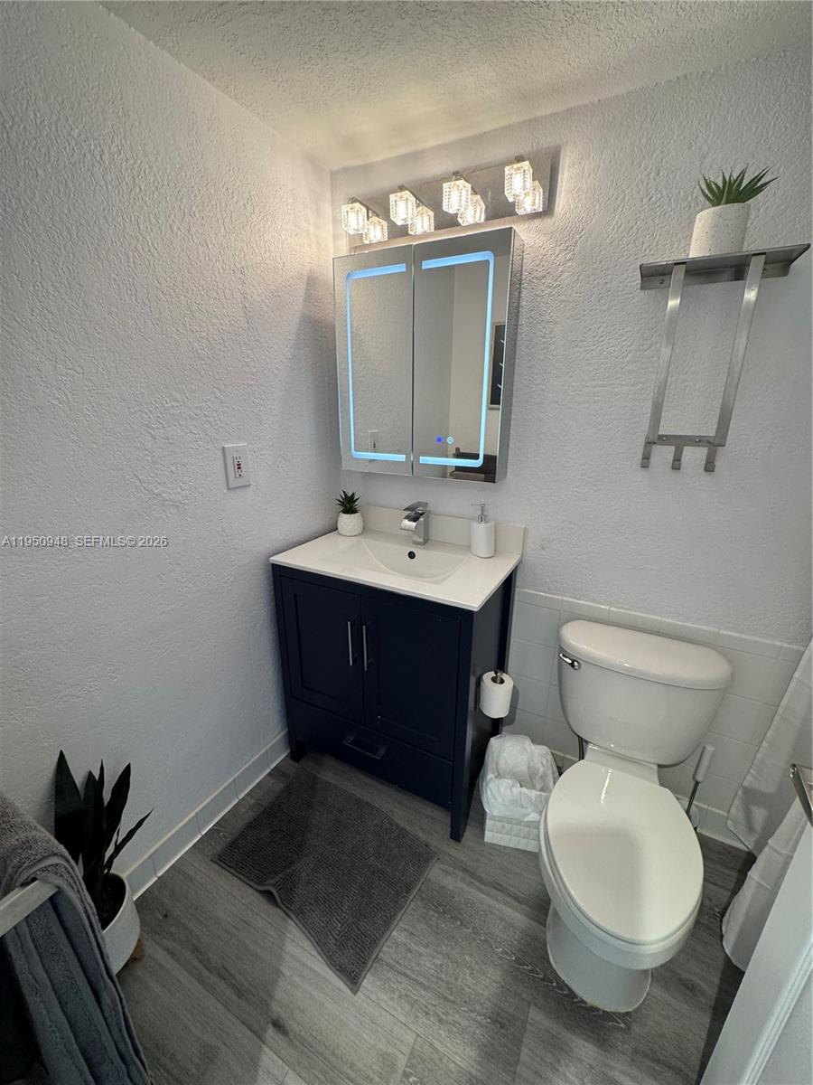 2501 South Ocean Drive, Unit 1105 Hollywood, FL 33019 - Photo 7 of 45 a bathroom with a toilet sink and mirror