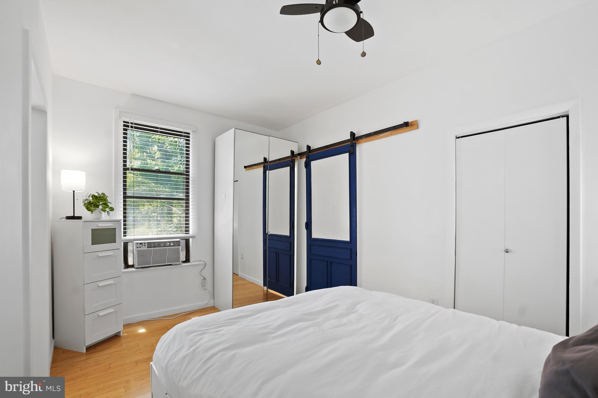 1822 15th Street Northwest, Unit 303 Washington, DC 20009 - Photo 12 of 22 a bedroom with a bed and wooden floor