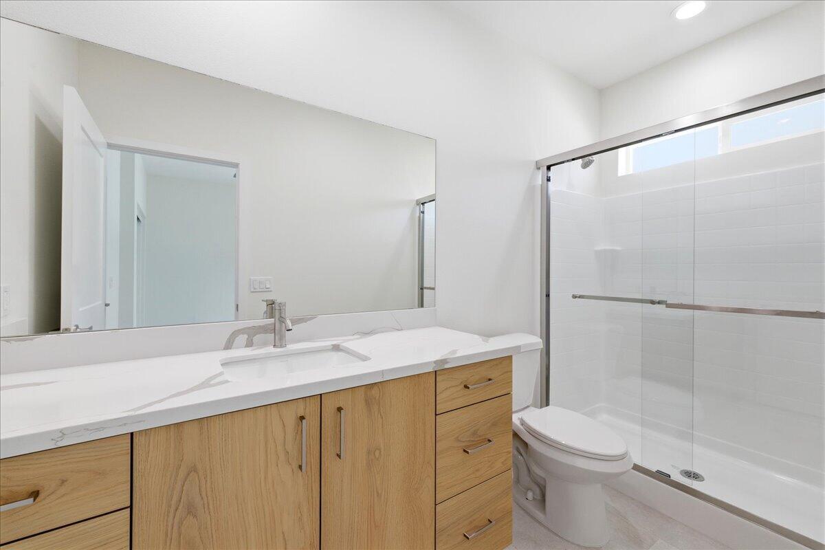68160 Modalo Road Cathedral City, CA 92234 - Photo 48 of 57 a bathroom with a shower sink vanity mirror and toilet
