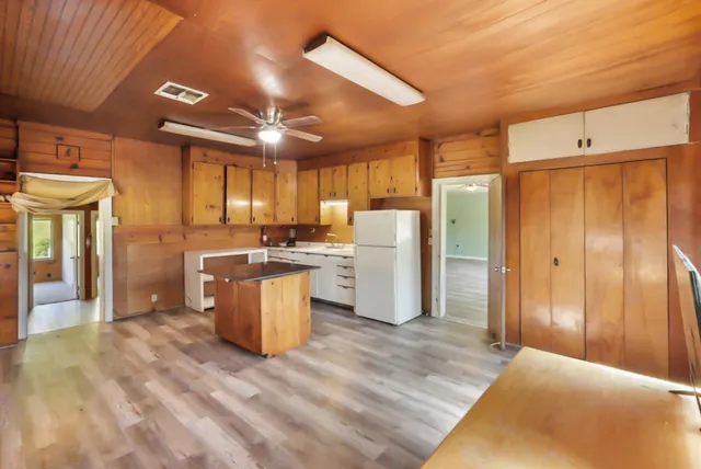 a kitchen with cabinets and wooden floor