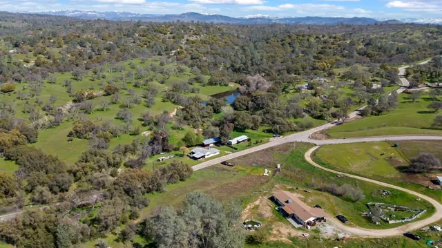 an aerial view of a house with outdoor space and parking