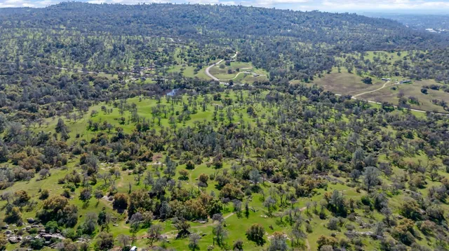 an aerial view of lake residential house with outdoor space and trees around