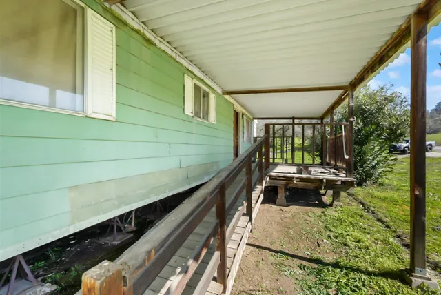 a view of an house with backyard space and balcony