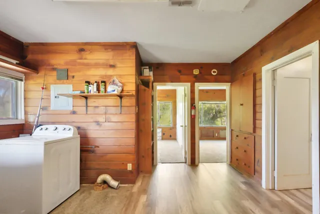 a view of a livingroom with furniture a ceiling fan and wooden floor