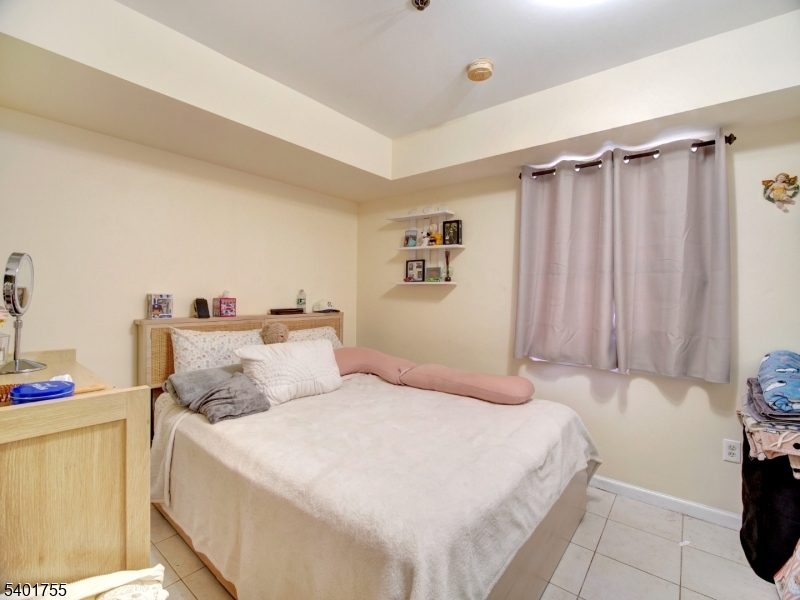 415 Loomis Street Elizabeth Port, NJ 07206 - Photo 11 of 27 a bedroom with a bed and a cabinets