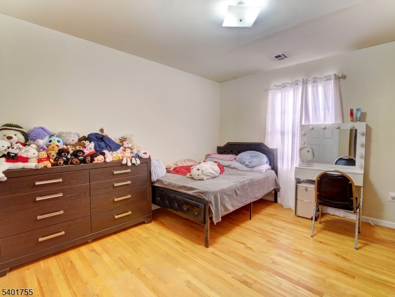 415 Loomis Street Elizabeth Port, NJ 07206 - Photo 19 of 27 a bedroom with a bed and window