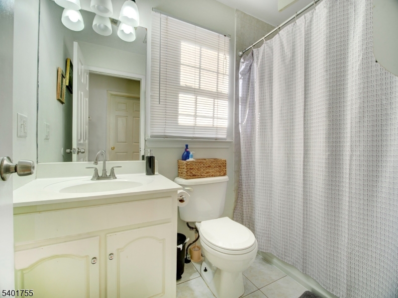 415 Loomis Street Elizabeth Port, NJ 07206 - Photo 20 of 27 a bathroom with a sink a toilet and mirror
