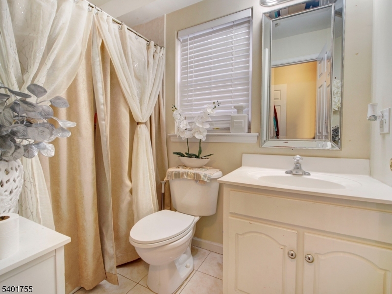 415 Loomis Street Elizabeth Port, NJ 07206 - Photo 22 of 27 a bathroom with a sink a toilet and a mirror