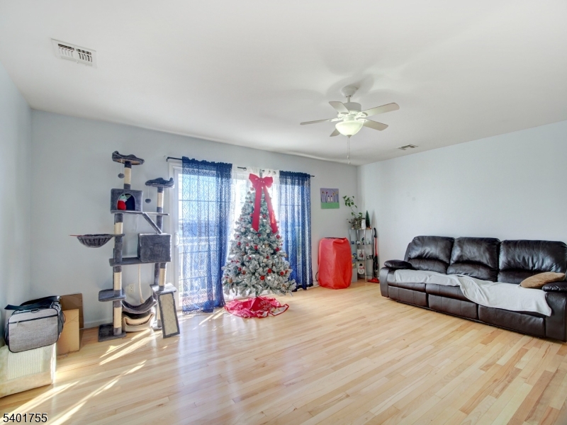 415 Loomis Street Elizabeth Port, NJ 07206 - Photo 4 of 27 a living room with furniture and a chandelier