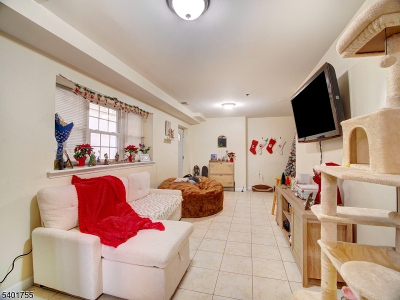415 Loomis Street Elizabeth Port, NJ 07206 - Photo 5 of 27 a living room with furniture and a flat screen tv