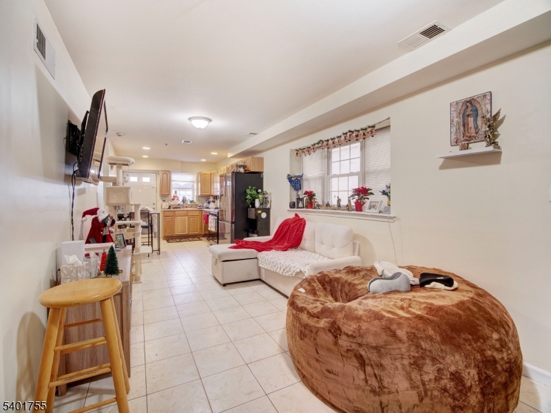 415 Loomis Street Elizabeth Port, NJ 07206 - Photo 6 of 27 a living room with furniture and a flat screen tv