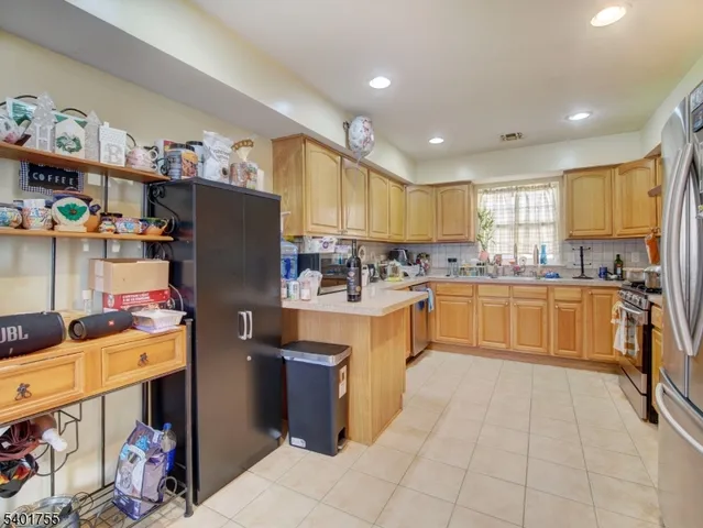 a kitchen with stainless steel appliances granite countertop a refrigerator sink and cabinets