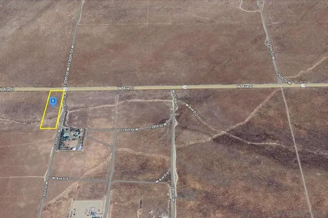 a view of an empty room and wooden floor
