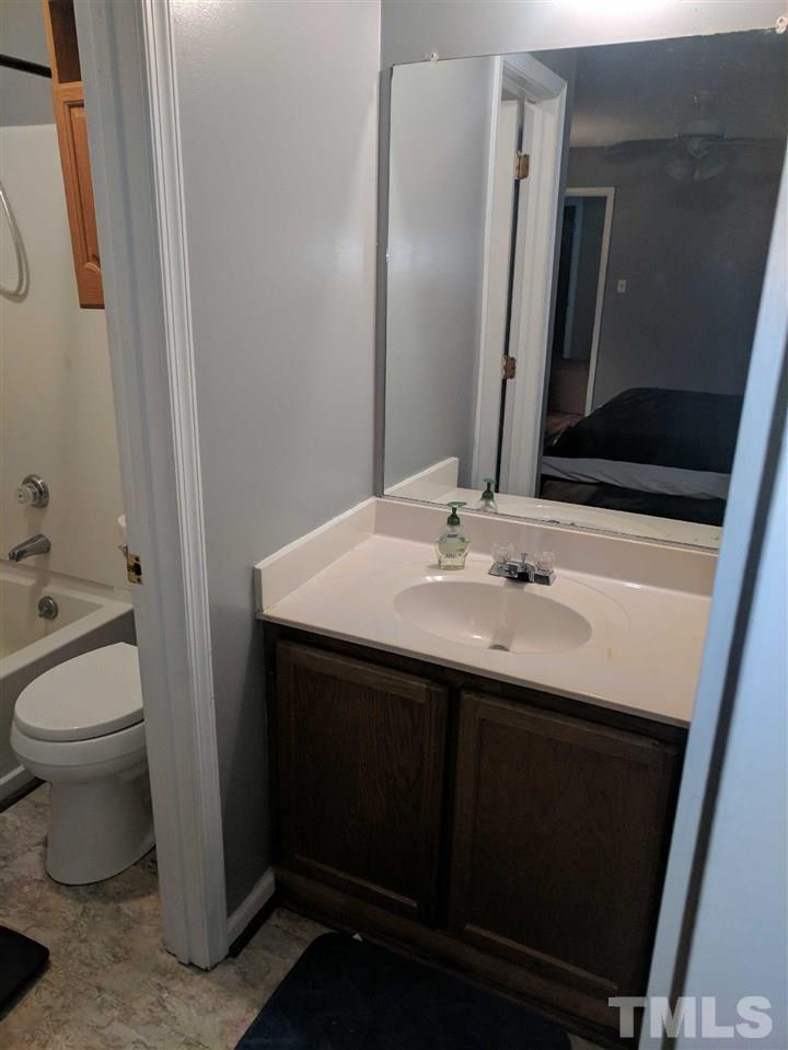 809 South Meadow Road Raleigh, NC 27603 - Photo 12 of 14 a bathroom with a sink toilet and mirror