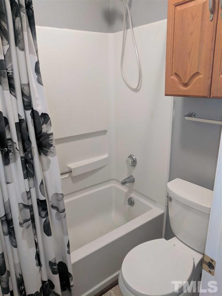 809 South Meadow Road Raleigh, NC 27603 - Photo 13 of 14 a white toilet sitting next to a bath tub