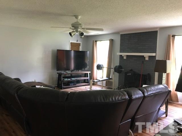 809 South Meadow Road Raleigh, NC 27603 - Photo 5 of 14 a living room with furniture and a flat screen tv