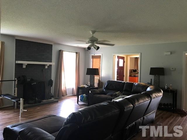 809 South Meadow Road Raleigh, NC 27603 - Photo 6 of 14 a living room with furniture a ceiling fan and a window