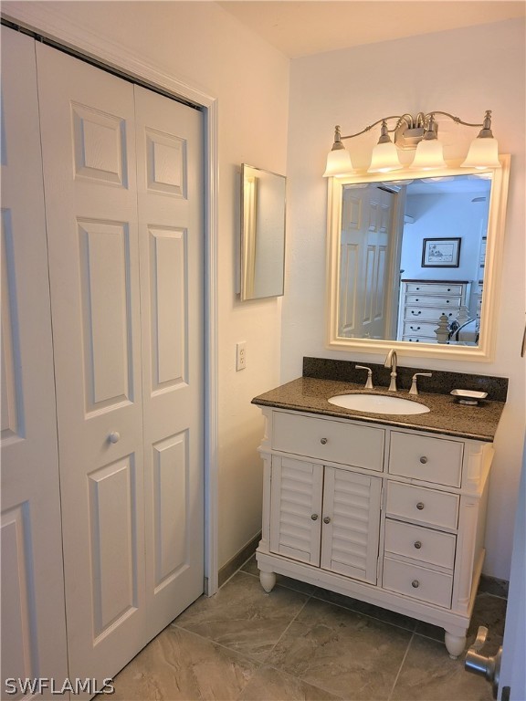 8071 Country Road, Unit 102 Fort Myers, FL 33919 - Photo 16 of 20 a bathroom with a sink and a mirror