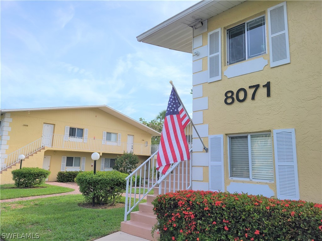 8071 Country Road, Unit 102 Fort Myers, FL 33919 - Photo 2 of 20 a view of a house with a yard and potted plants