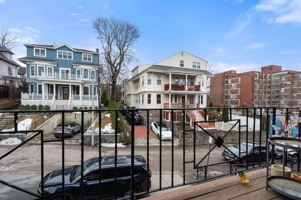a front view of a building with glass windows and a table