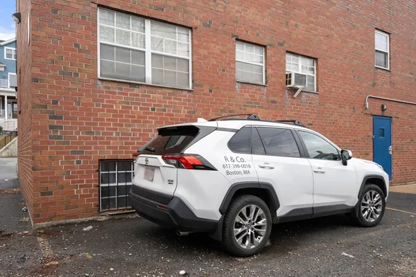 a view of a car in front of a brick building