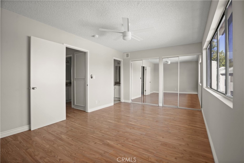 11311 Tampa Avenue, Unit 21 Porter Ranch, CA 91326 - Photo 16 of 36 a view of empty room with wooden floor and fan