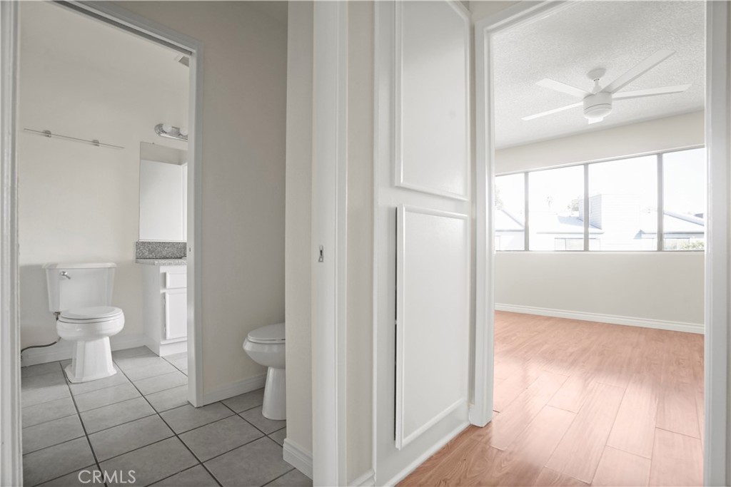 11311 Tampa Avenue, Unit 21 Porter Ranch, CA 91326 - Photo 21 of 36 a bathroom with a granite countertop toilet and a shower