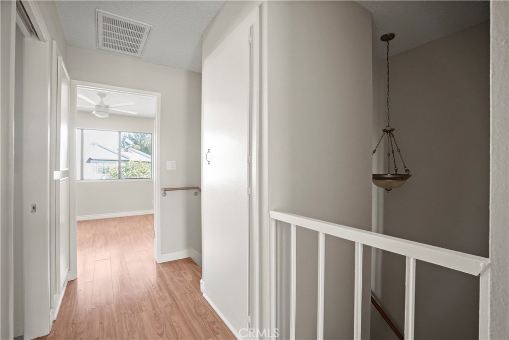 11311 Tampa Avenue, Unit 21 Porter Ranch, CA 91326 - Photo 27 of 36 a view of hallway with wooden floor
