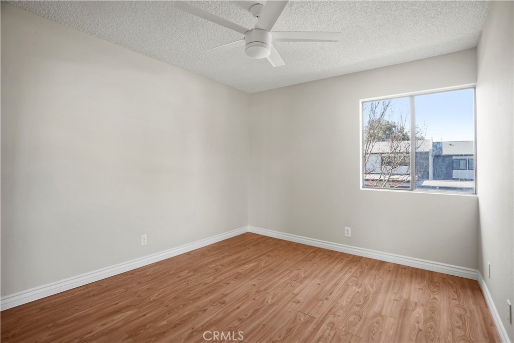 11311 Tampa Avenue, Unit 21 Porter Ranch, CA 91326 - Photo 28 of 36 an empty room with wooden floor and windows