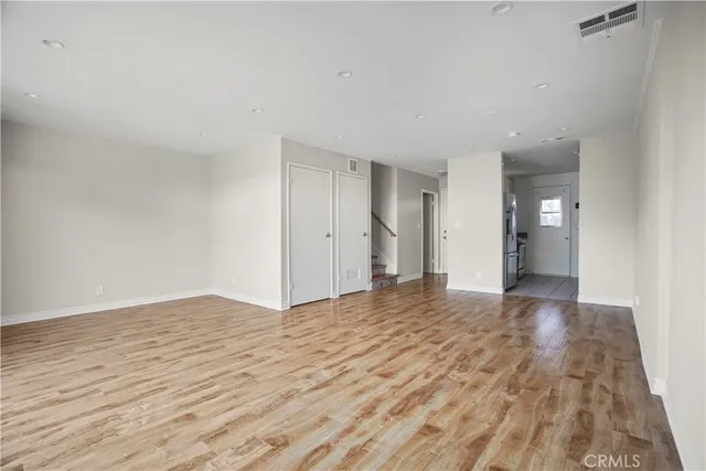 a view of an empty room and wooden floor