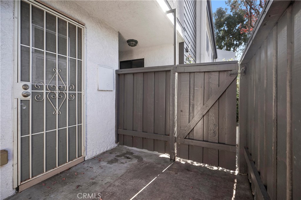 11311 Tampa Avenue, Unit 21 Porter Ranch, CA 91326 - Photo 34 of 36 a view of a house with backyard and wooden door