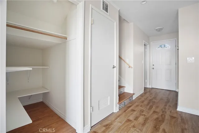 a view of hallway with wooden floor