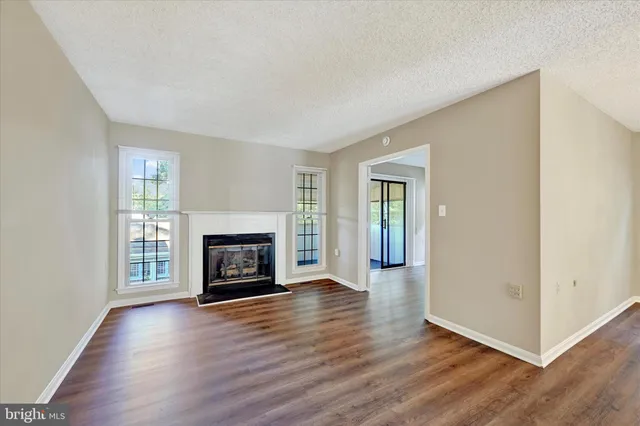 a view of an empty room and wooden floor
