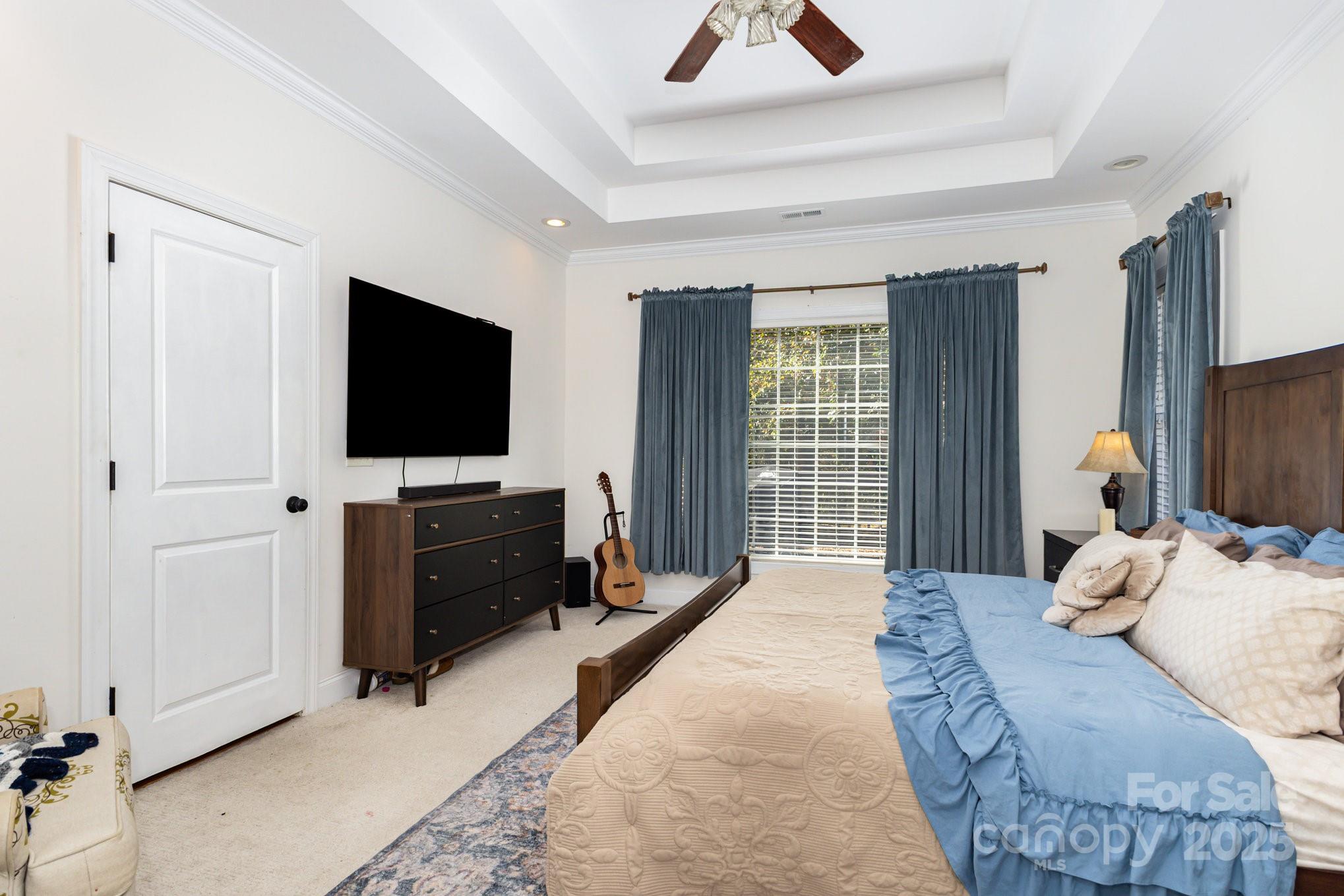 324 Old Hardin Road Dallas, NC 28034 - Photo 19 of 35 a bedroom with a bed and a flat tv screen on wall