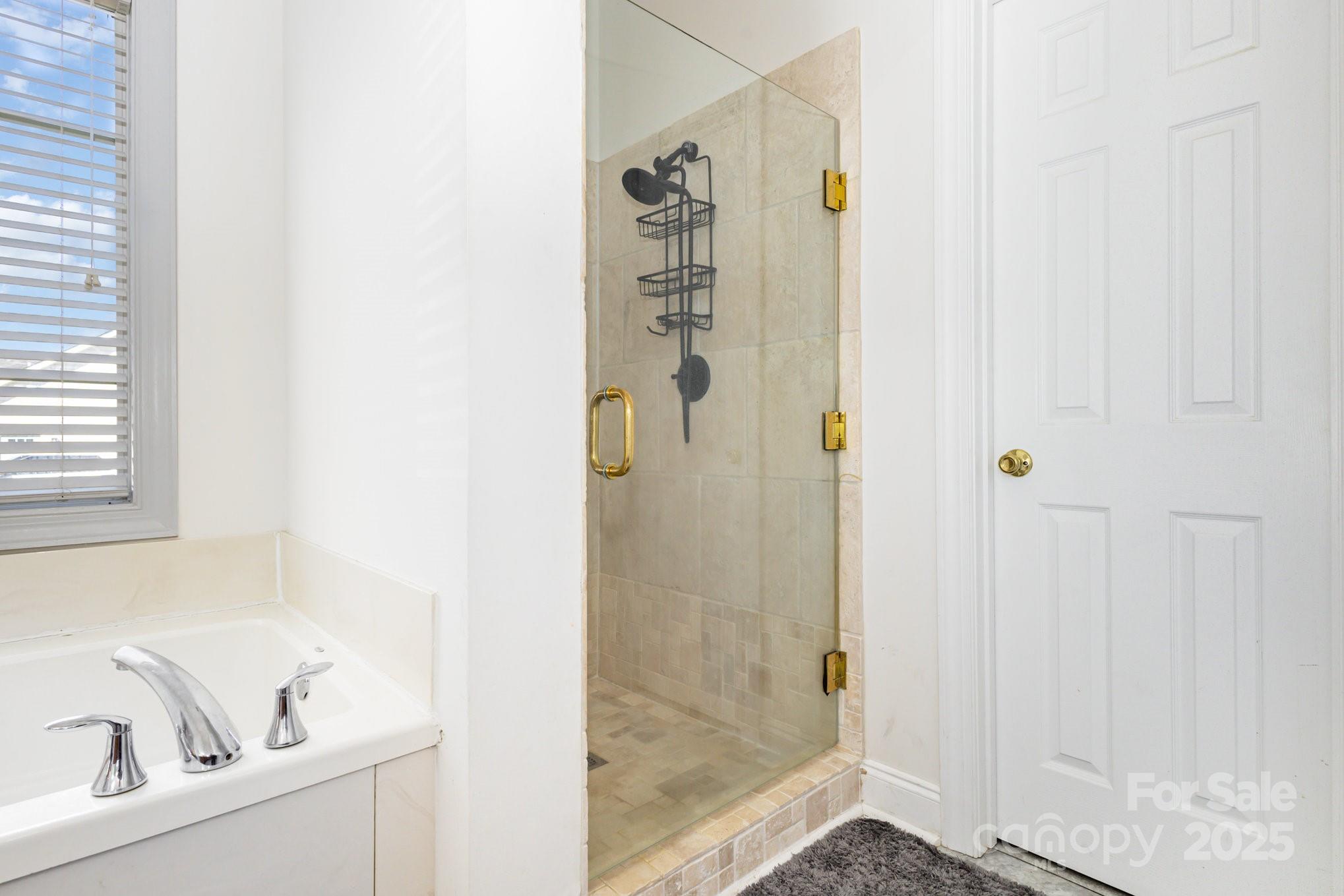 324 Old Hardin Road Dallas, NC 28034 - Photo 21 of 35 a bathroom with a bathtub and a shower