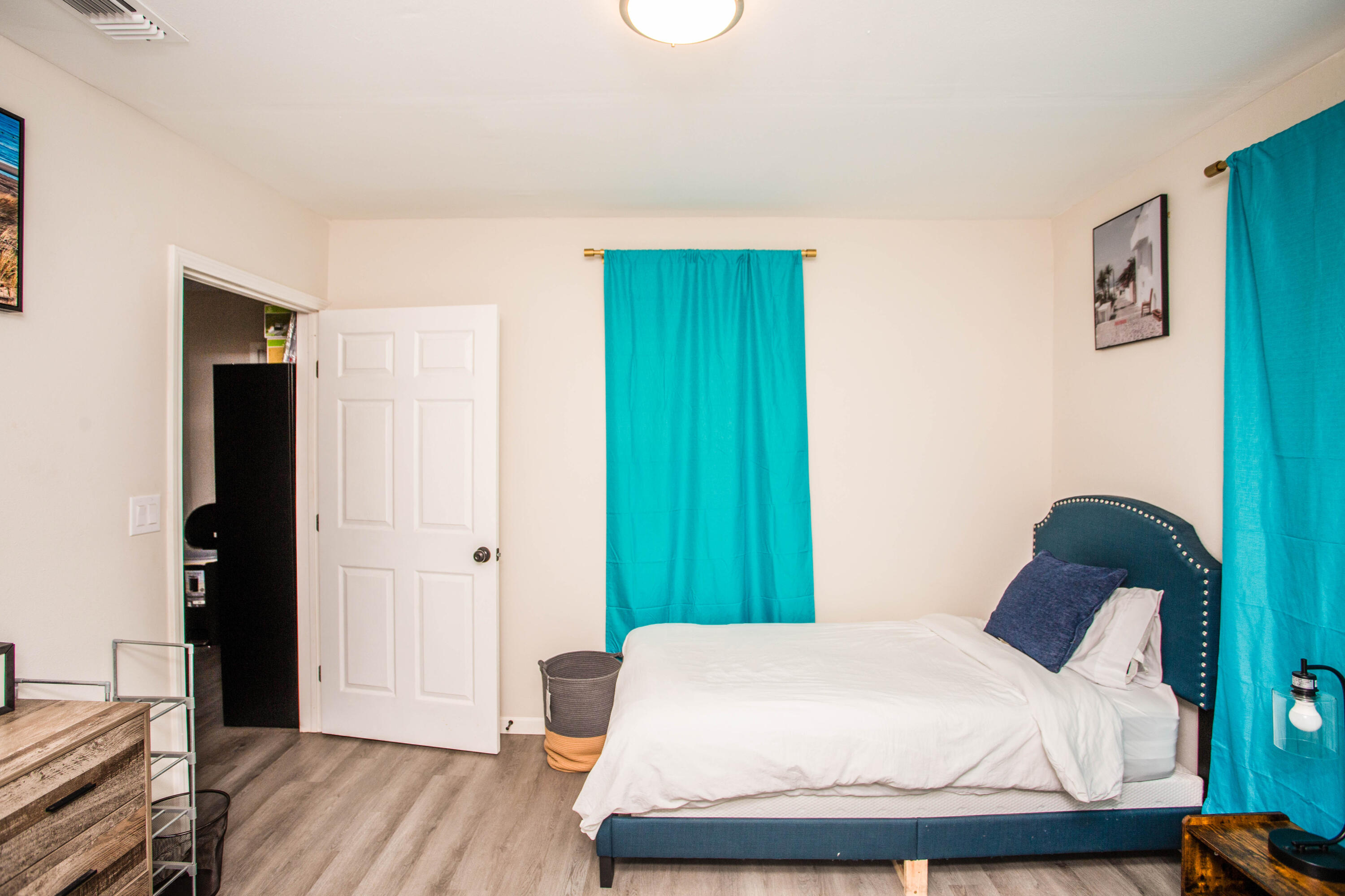 2808 Amherst Street Lubbock, TX 79415 - Photo 19 of 26 a bedroom with a bed and wooden floor