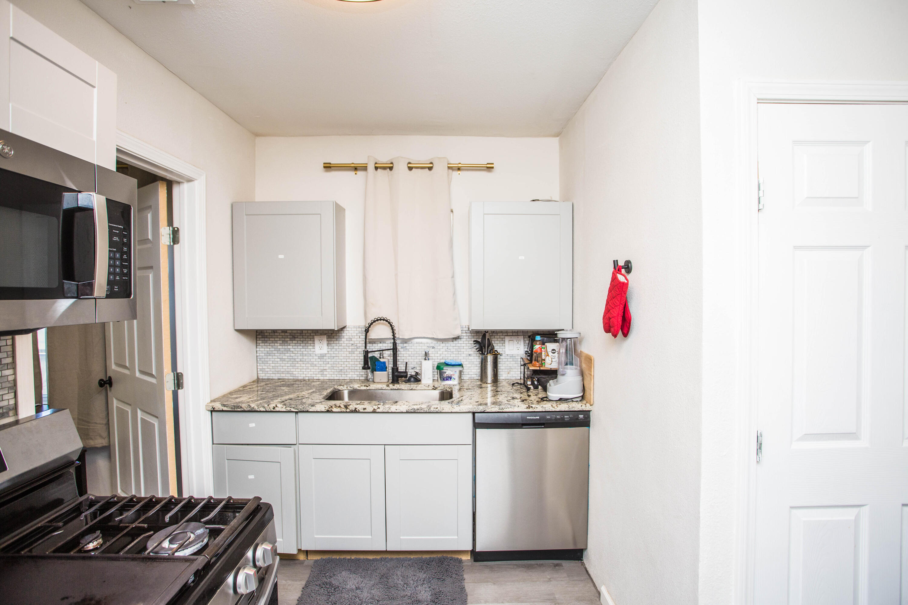 2808 Amherst Street Lubbock, TX 79415 - Photo 8 of 26 a kitchen with a sink stove and refrigerator