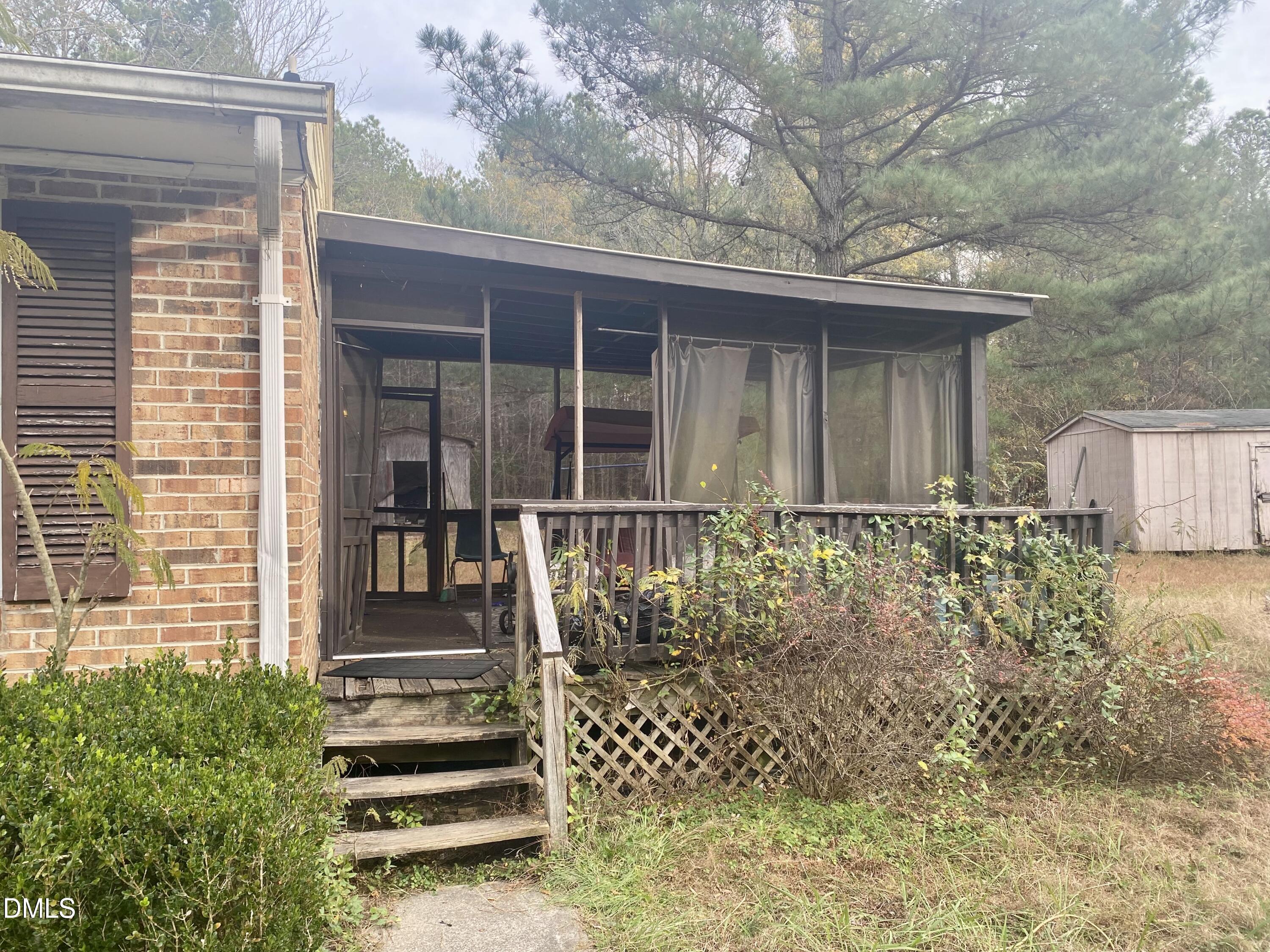 142 Kings Road Henderson, NC 27537 - Photo 3 of 9 a front view of a house with a garden