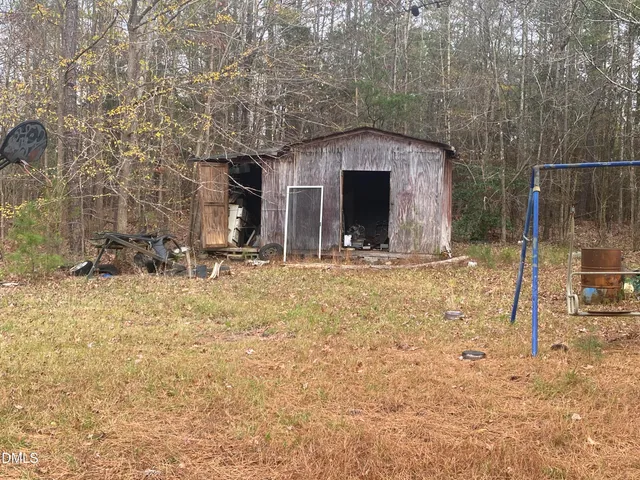 a front view of a house with two yard