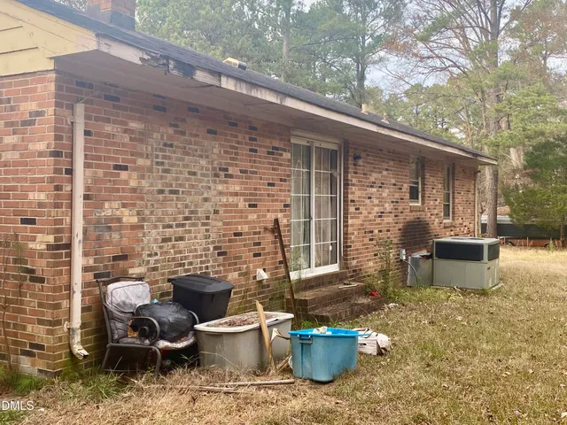 a backyard of a house with outdoor seating