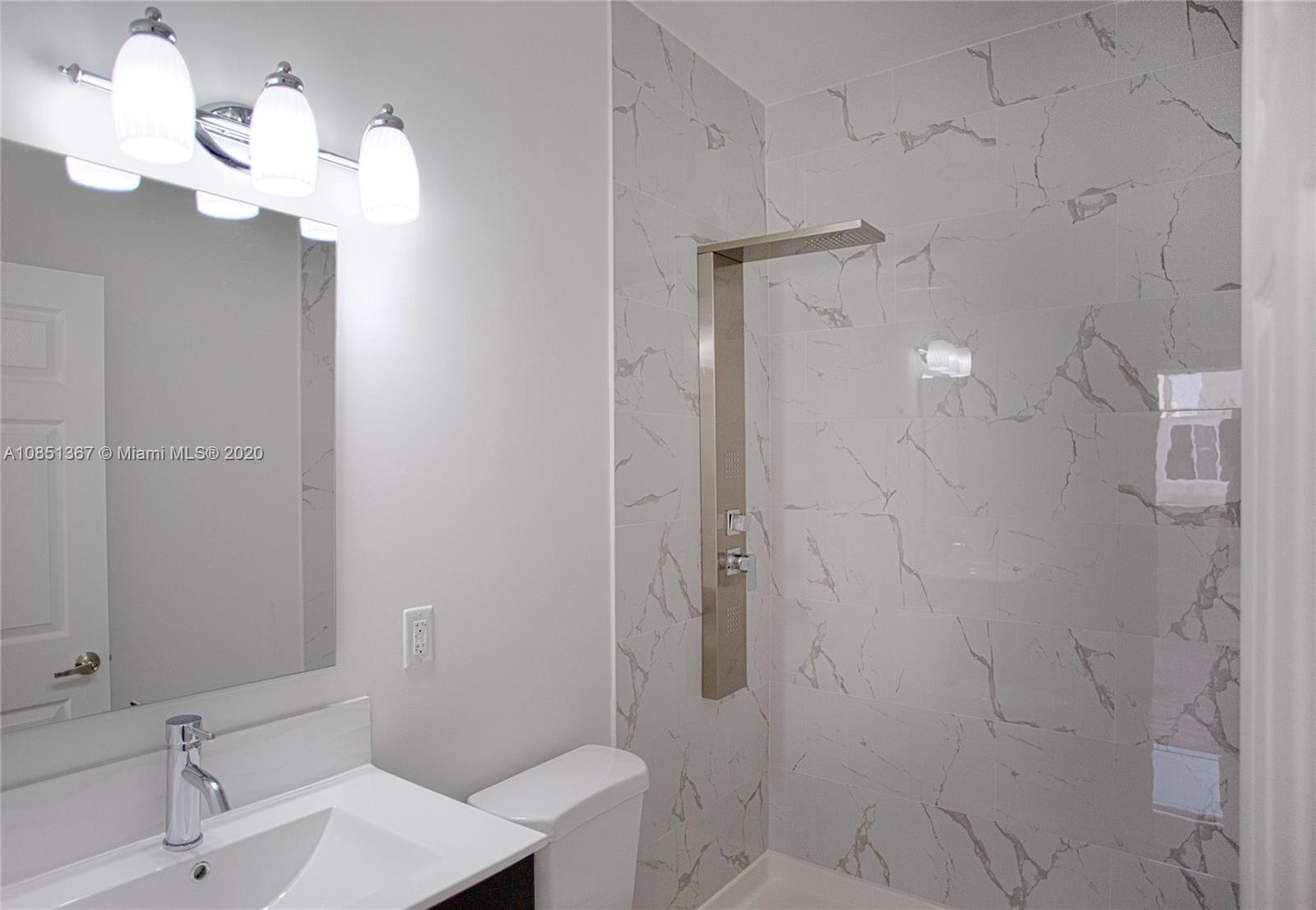 13724 Southwest 259th Street Homestead, FL 33032 - Photo 17 of 20 a bathroom with a sink a toilet and shower