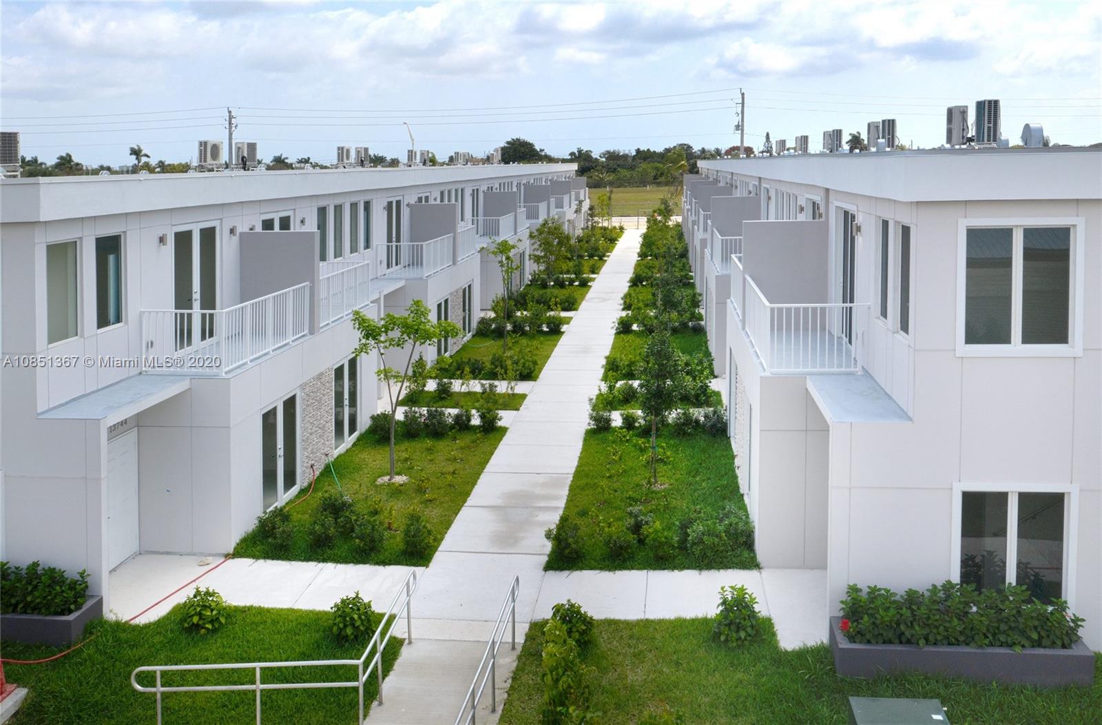 13724 Southwest 259th Street Homestead, FL 33032 - Photo 2 of 20 a view of a house with a yard and potted plants