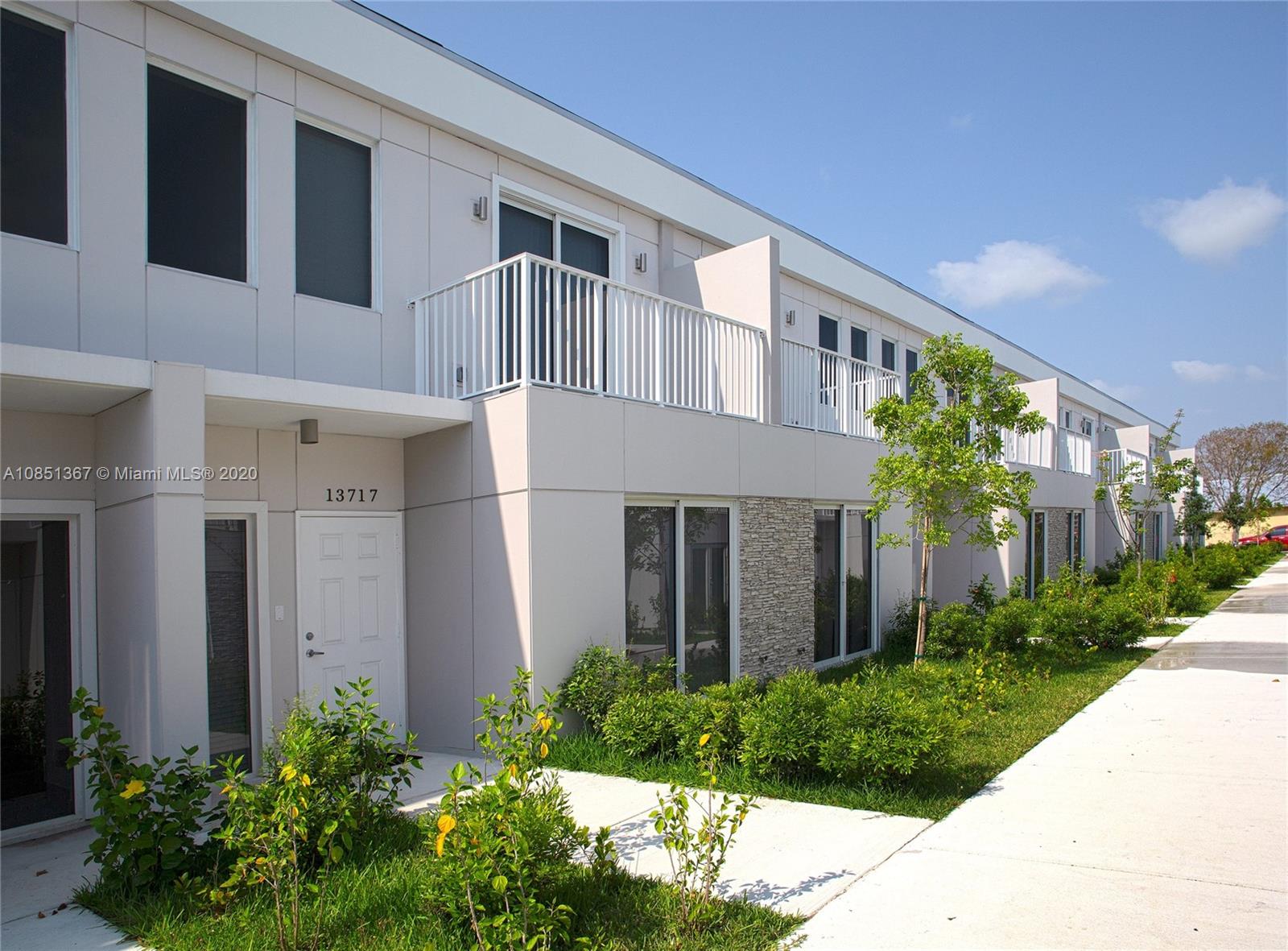 13724 Southwest 259th Street Homestead, FL 33032 - Photo 3 of 20 a front view of a house with garden