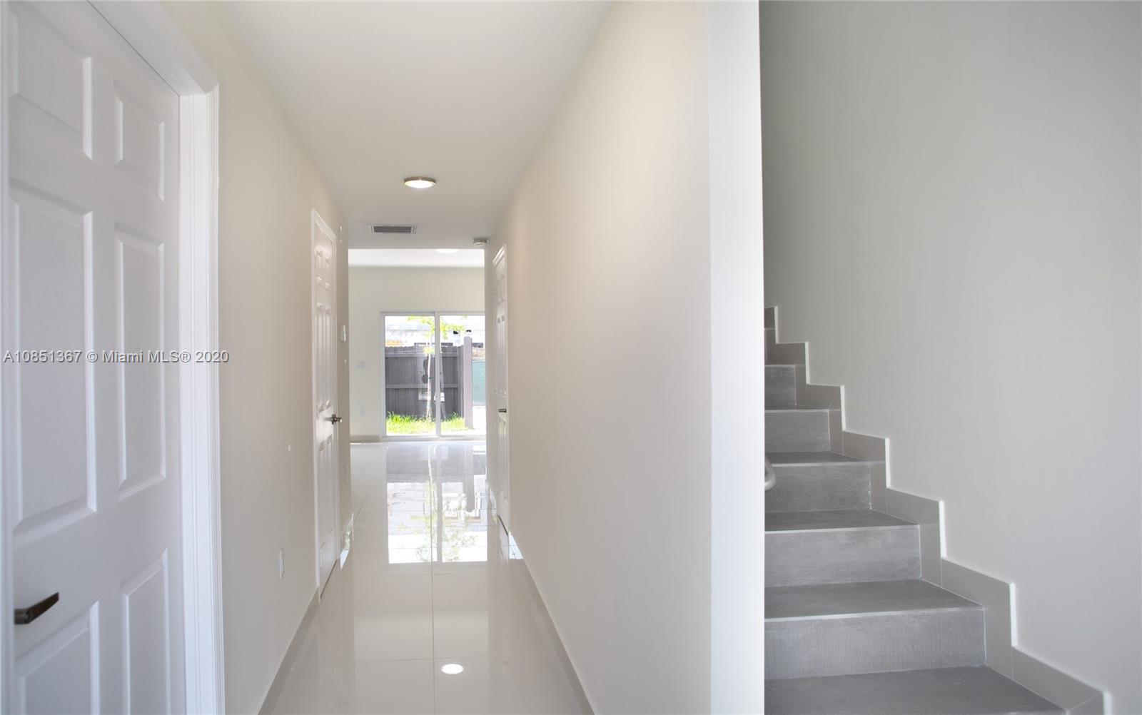 13724 Southwest 259th Street Homestead, FL 33032 - Photo 5 of 20 a view of a hallway with wooden floor and entryway