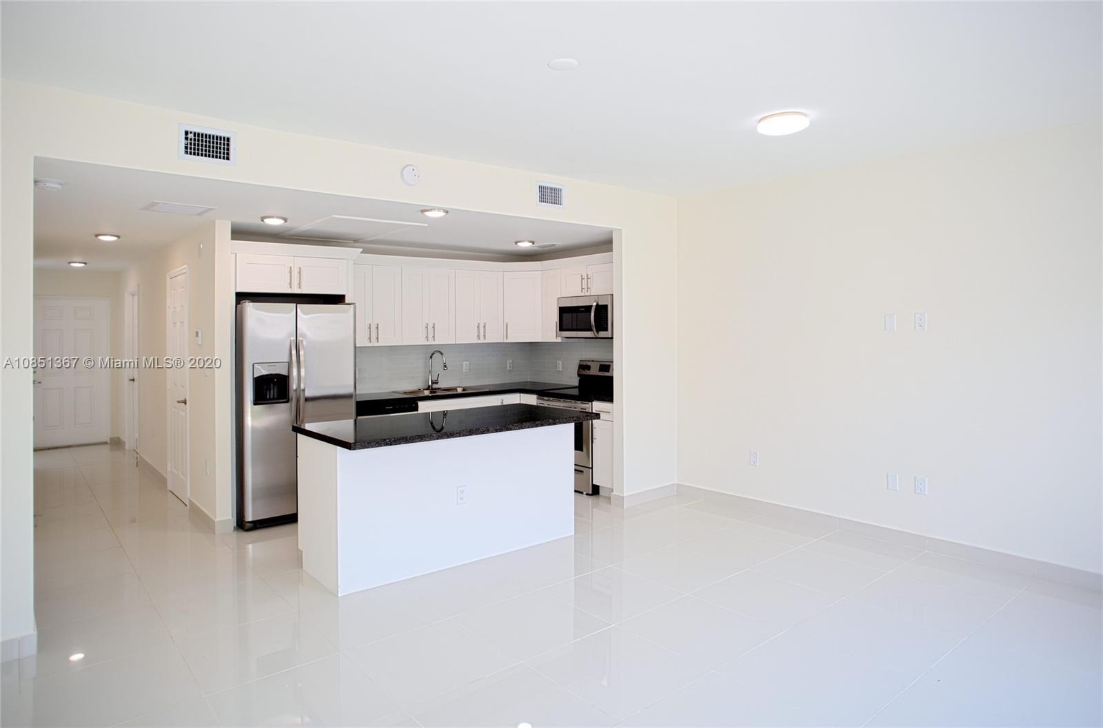 13724 Southwest 259th Street Homestead, FL 33032 - Photo 6 of 20 a kitchen with a sink cabinets and stainless steel appliances