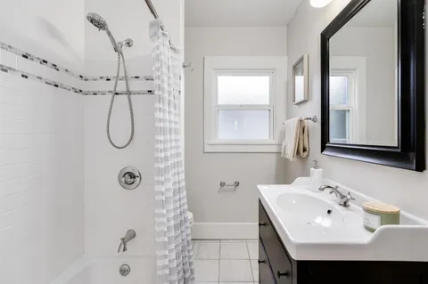 a bathroom with a sink a mirror and a shower