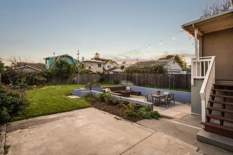 a view of a house with backyard and porch