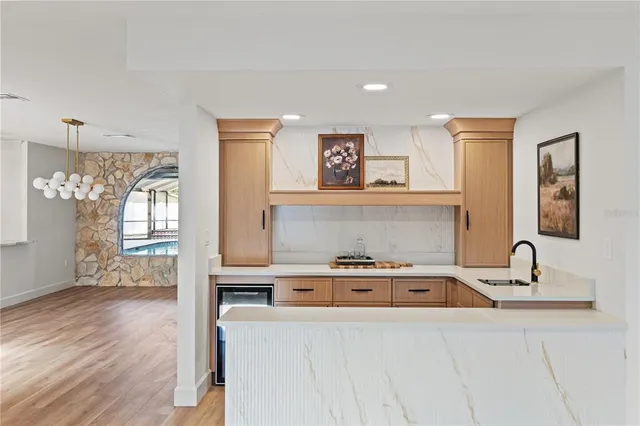 a view of empty room with wooden floor and ceiling fan