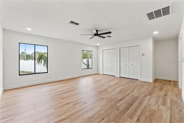 a spacious bathroom with a granite countertop sink a mirror and a